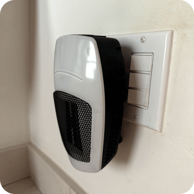 Heater plugged into a wall outlet.
